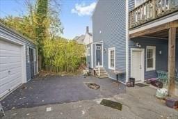 view of property exterior with a garage and a patio