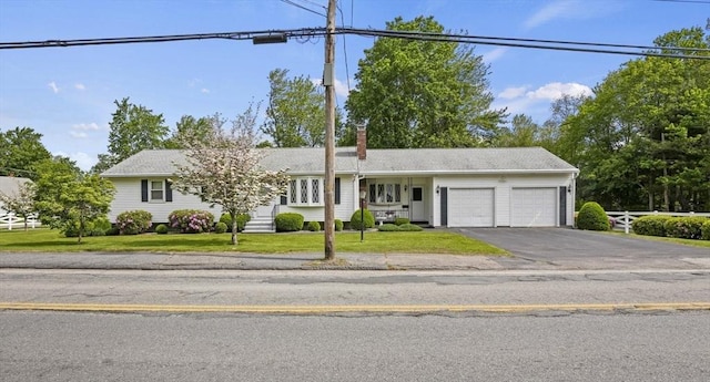 395 Franklin Rd, Fitchburg, MA 01420 - ranch-style home with a garage, asphalt driveway, a chimney, and a front lawn