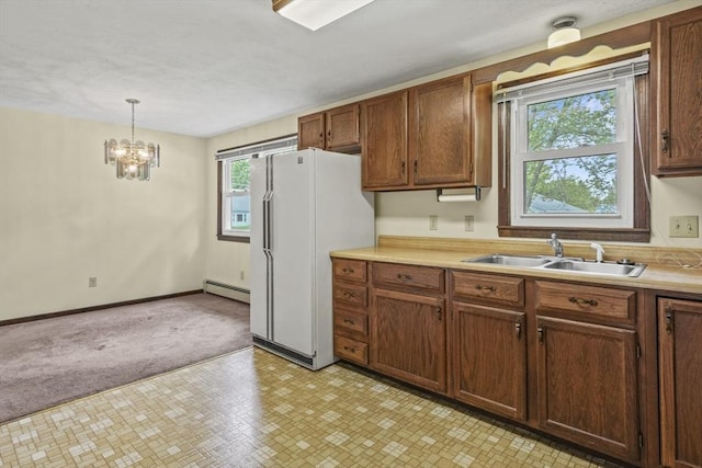 395 Franklin Rd, Fitchburg, MA 01420 - kitchen with baseboard heating, a sink, light countertops, a chandelier, and freestanding refrigerator