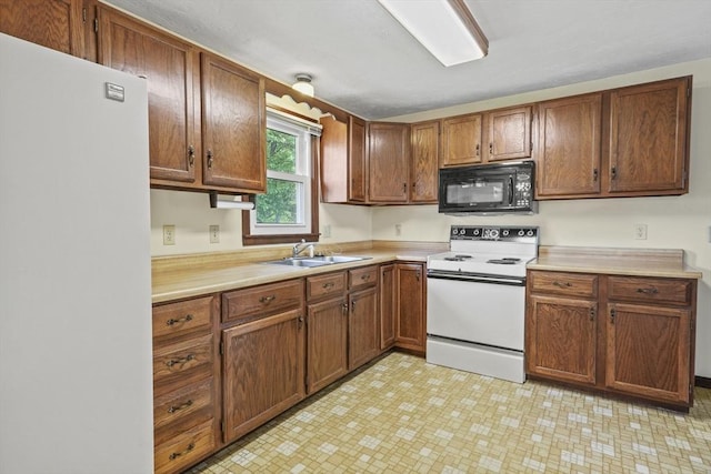 395 Franklin Rd, Fitchburg, MA 01420 - kitchen with white appliances, a sink, light countertops, brown cabinetry, and light floors