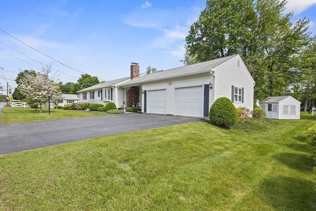 395 Franklin Rd, Fitchburg, MA 01420 - single story home with a garage, driveway, a chimney, and a front lawn