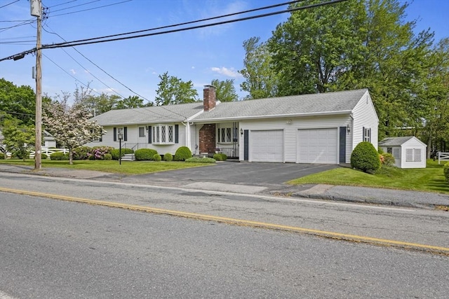 395 Franklin Rd, Fitchburg, MA 01420 - ranch-style house with an attached garage, asphalt driveway, a chimney, and a front yard