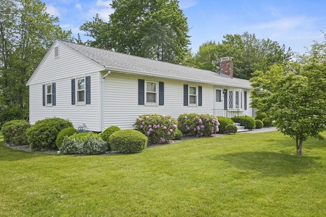 395 Franklin Rd, Fitchburg, MA 01420 - view of home's exterior featuring a chimney, a lawn, and a shingled roof
