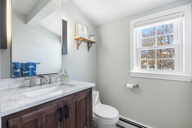 half bathroom featuring toilet, a baseboard radiator, vaulted ceiling, and vanity