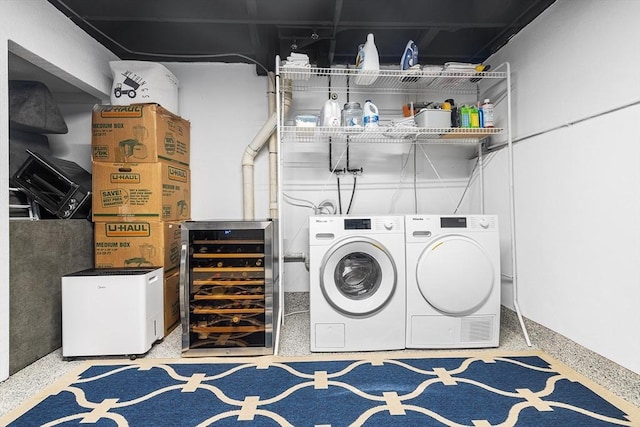 clothes washing area with wine cooler, laundry area, and washing machine and clothes dryer