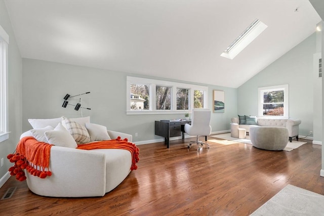 living room featuring a skylight, wood finished floors, visible vents, and baseboards