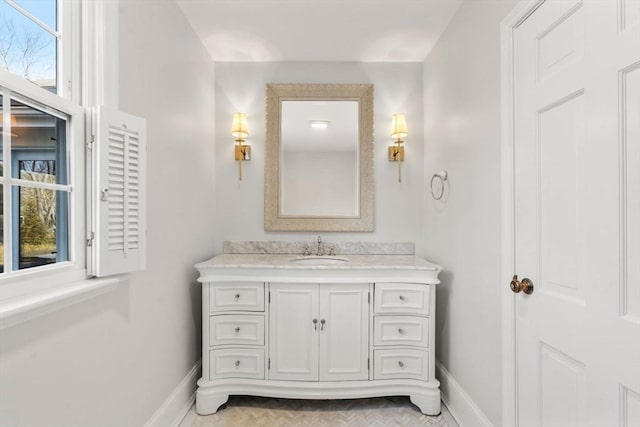 bathroom with baseboards and vanity