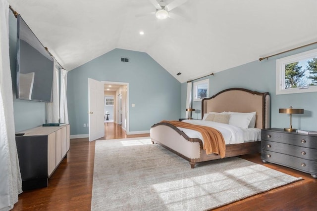 bedroom featuring visible vents, baseboards, lofted ceiling, wood finished floors, and a ceiling fan