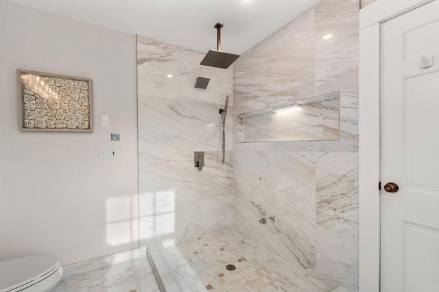 full bath featuring toilet and a marble finish shower