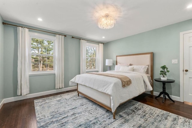 bedroom featuring a notable chandelier, recessed lighting, baseboards, and wood finished floors