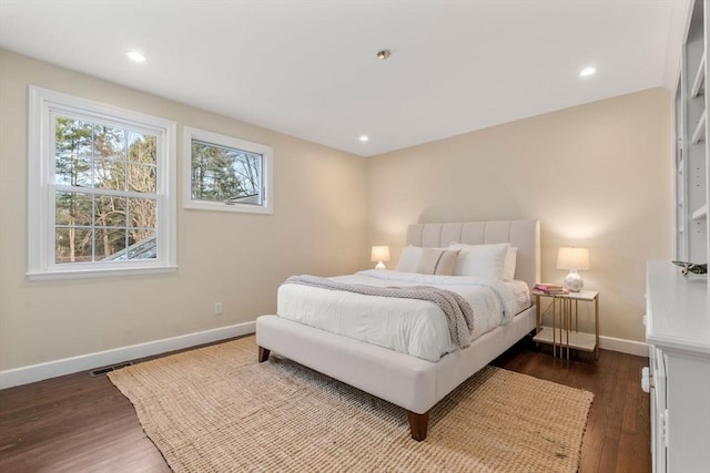 bedroom featuring dark wood finished floors, visible vents, recessed lighting, and baseboards