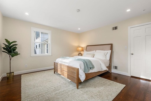 bedroom with recessed lighting, wood finished floors, visible vents, and baseboards