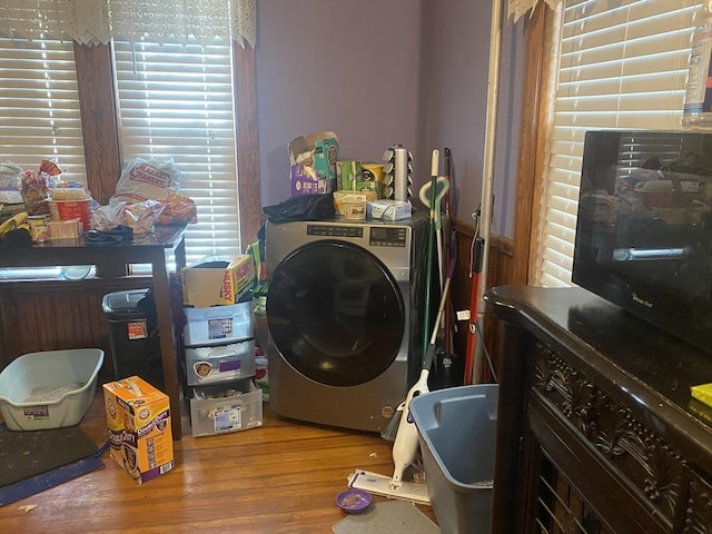 laundry area with laundry area, washer / clothes dryer, and wood finished floors