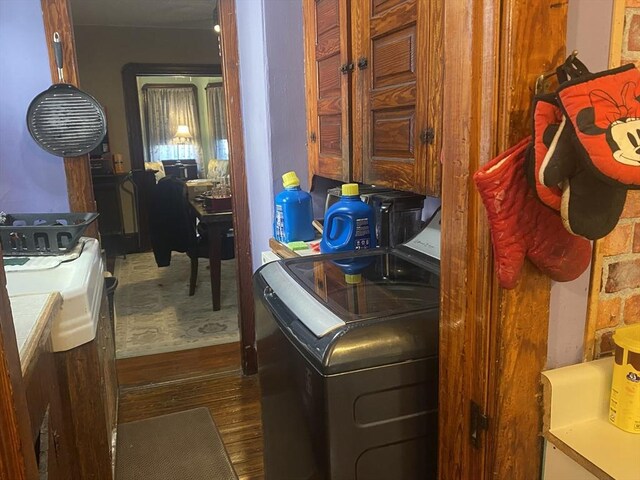 laundry area with washer / clothes dryer, dark wood-style flooring, and laundry area