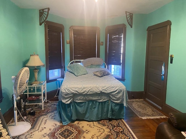 bedroom with baseboards and wood finished floors