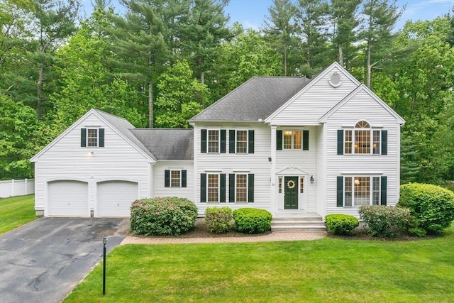 21 Butterfield Ln, Westford, MA 01886 - view of front of house with driveway, an attached garage, a front lawn, and roof with shingles