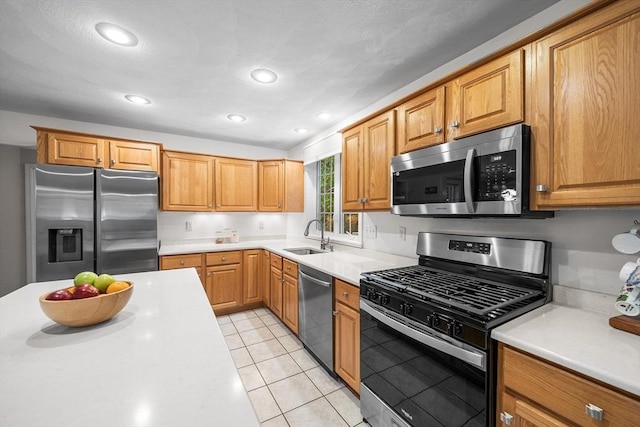 21 Butterfield Ln, Westford, MA 01886 - kitchen featuring appliances with stainless steel finishes, a sink, light countertops, light tile patterned flooring, and recessed lighting