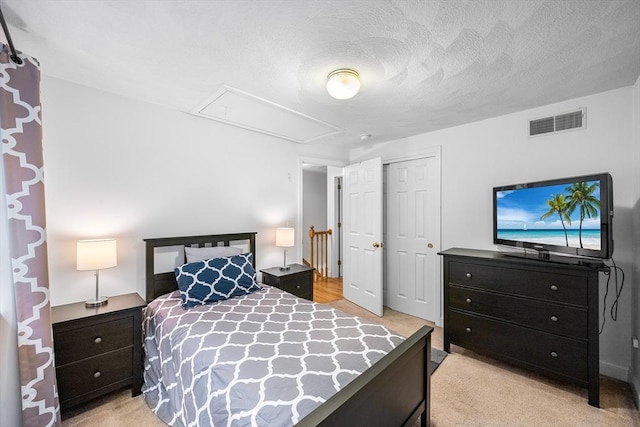 21 Butterfield Ln, Westford, MA 01886 - bedroom featuring attic access, a closet, light colored carpet, and a textured ceiling