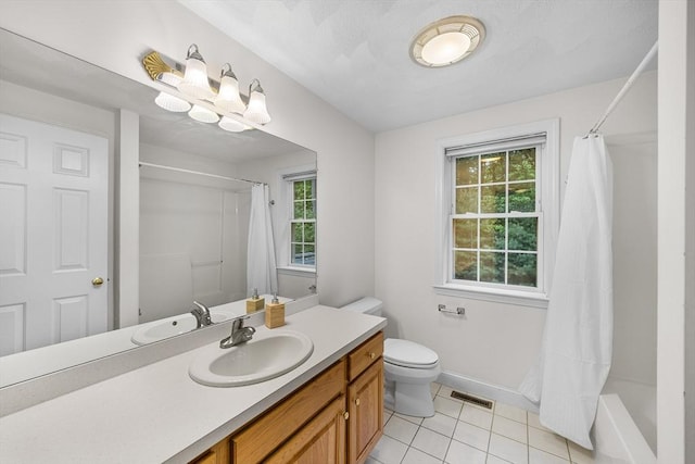 21 Butterfield Ln, Westford, MA 01886 - full bath with tile patterned flooring, vanity, plenty of natural light, and toilet