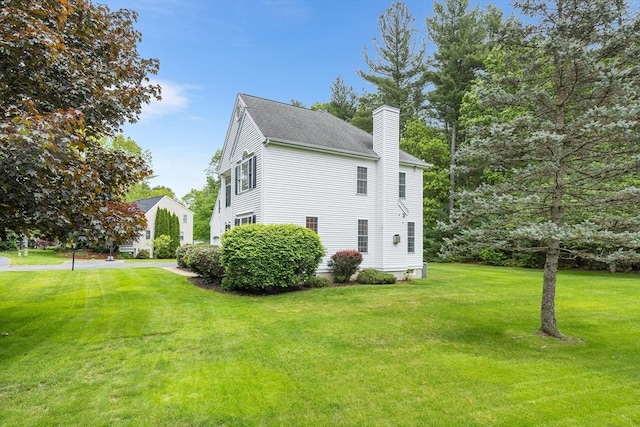 21 Butterfield Ln, Westford, MA 01886 - view of property exterior with a chimney and a lawn