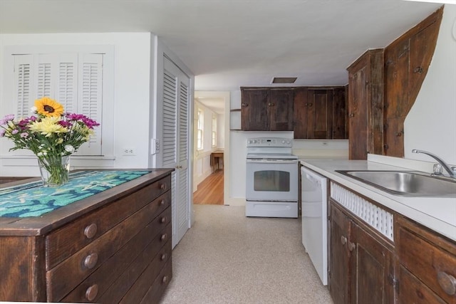 40 Scotchmans Ln, West Tisbury, MA 02575 - kitchen featuring white appliances, dark brown cabinetry, and light countertops