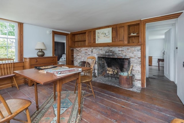 40 Scotchmans Ln, West Tisbury, MA 02575 - dining room featuring dark wood finished floors and a brick fireplace