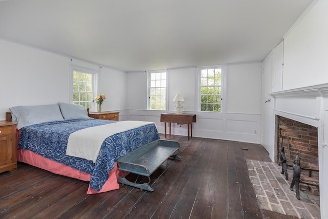 40 Scotchmans Ln, West Tisbury, MA 02575 - bedroom featuring hardwood / wood-style flooring, a fireplace, wainscoting, and a decorative wall