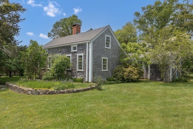 40 Scotchmans Ln, West Tisbury, MA 02575 - view of property exterior featuring a chimney, a lawn, and a shingled roof