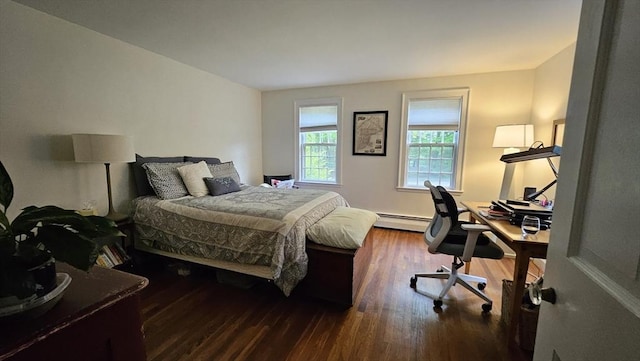 bedroom featuring a baseboard radiator, wood finished floors, and an office area