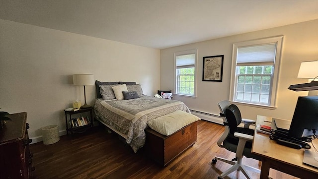 bedroom with a baseboard radiator, wood finished floors, a desk, and baseboards