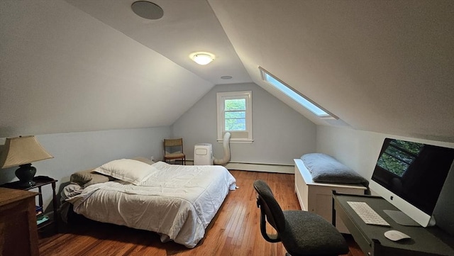 bedroom with a baseboard radiator, wood finished floors, vaulted ceiling, a skylight, and baseboards