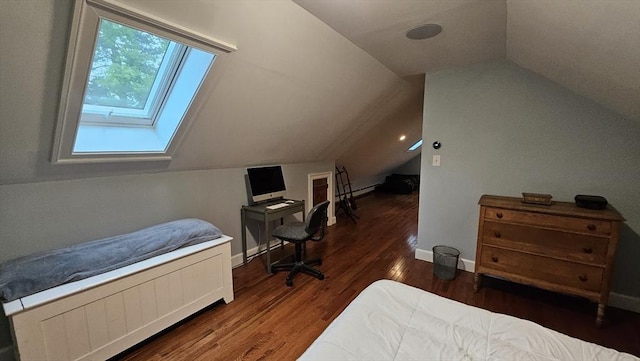 bedroom with lofted ceiling, a skylight, wood finished floors, and baseboards