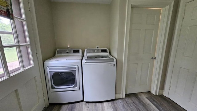 laundry room featuring washing machine and clothes dryer and wood finished floors