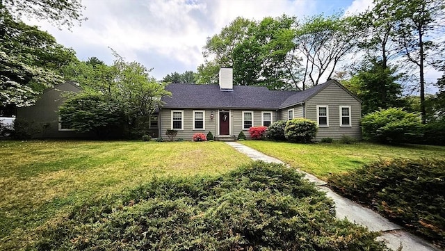 ranch-style house with a chimney, a front lawn, and entry steps