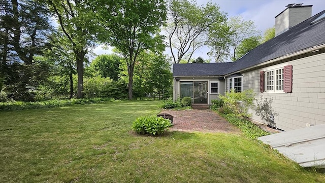 view of green lawn featuring a patio area