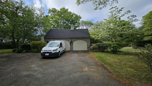 garage with asphalt driveway