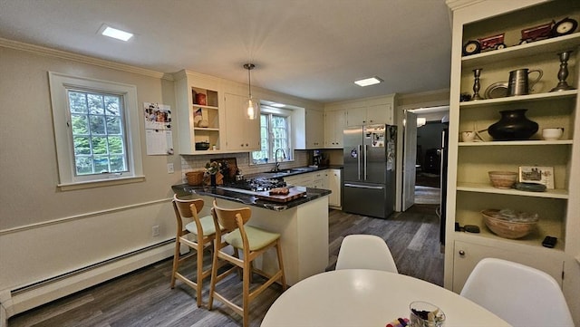 kitchen featuring high quality fridge, open shelves, a sink, a baseboard radiator, and dark wood-style floors