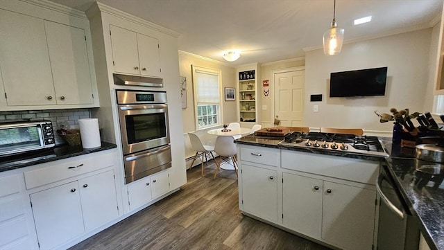 kitchen featuring a warming drawer, appliances with stainless steel finishes, crown molding, dark wood-style flooring, and white cabinetry