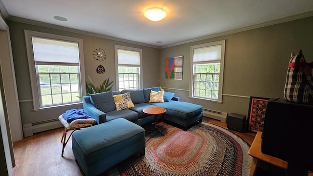 living room with a baseboard heating unit, wood finished floors, and ornamental molding