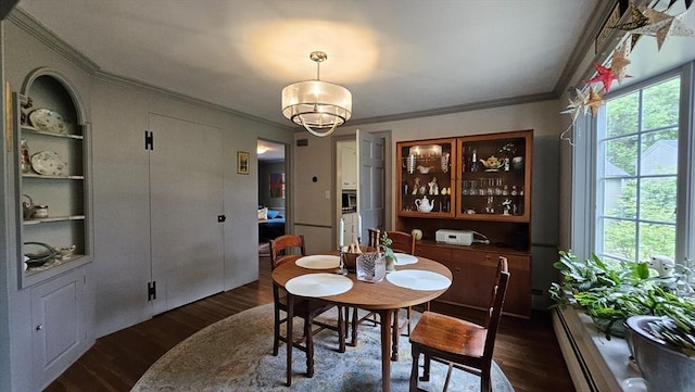 dining space featuring crown molding, dark wood-style flooring, a baseboard radiator, plenty of natural light, and a chandelier