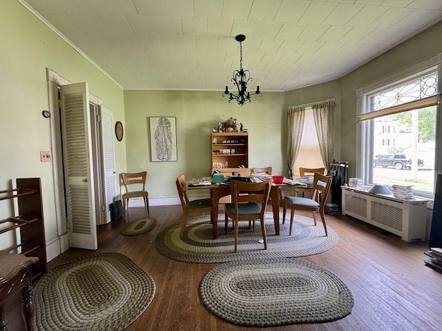 78 Allyn St, Holyoke, MA 01040 - dining area with ornamental molding, wood finished floors, a chandelier, radiator heating unit, and baseboards