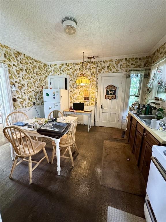 78 Allyn St, Holyoke, MA 01040 - dining area featuring wallpapered walls, a wainscoted wall, and an office area