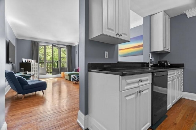 kitchen with wood finished floors, dishwasher, white cabinets, and dark countertops