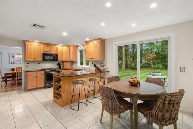 67 Flanagan Dr, Framingham, MA 01701 - kitchen with black microwave, stainless steel range with gas cooktop, dark countertops, open shelves, and recessed lighting