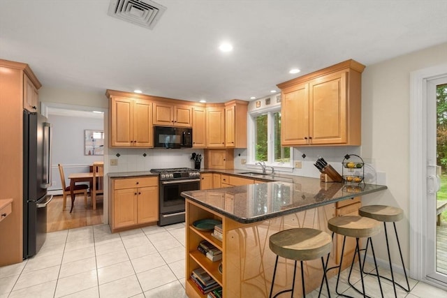 67 Flanagan Dr, Framingham, MA 01701 - kitchen with black appliances, a peninsula, plenty of natural light, dark stone counters, and recessed lighting