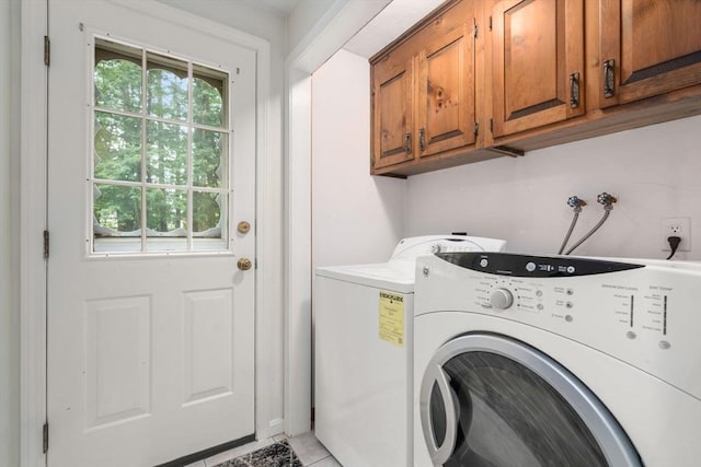 67 Flanagan Dr, Framingham, MA 01701 - laundry room featuring cabinet space, washing machine and dryer, and light tile patterned floors