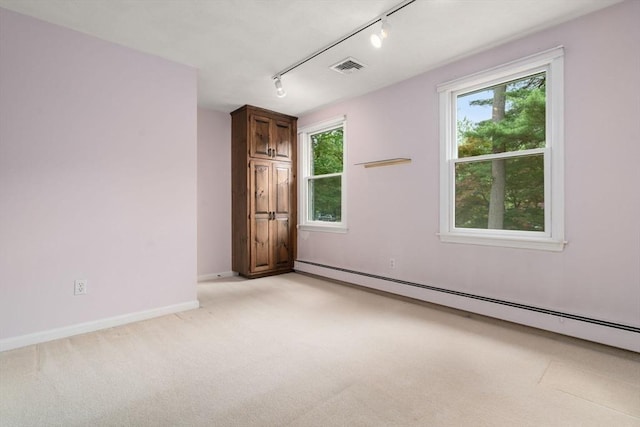 67 Flanagan Dr, Framingham, MA 01701 - spare room featuring a baseboard radiator, rail lighting, and light colored carpet