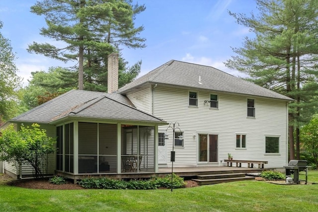 67 Flanagan Dr, Framingham, MA 01701 - back of house with a chimney, a sunroom, a deck, a shingled roof, and a yard