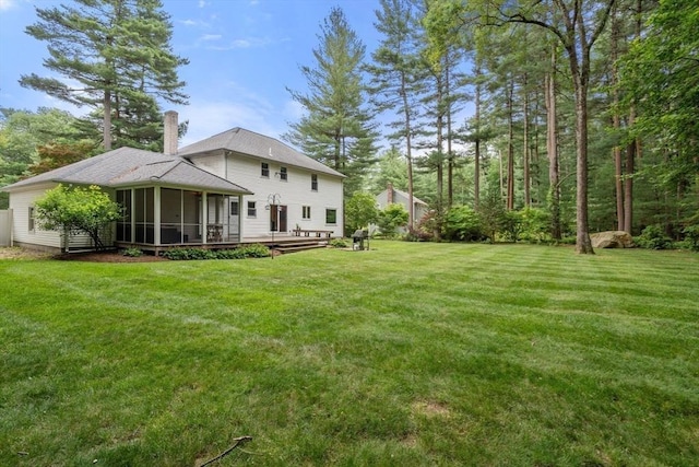 67 Flanagan Dr, Framingham, MA 01701 - view of green lawn with a sunroom and a deck