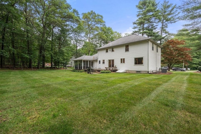 67 Flanagan Dr, Framingham, MA 01701 - rear view of property with a sunroom, a yard, and a deck
